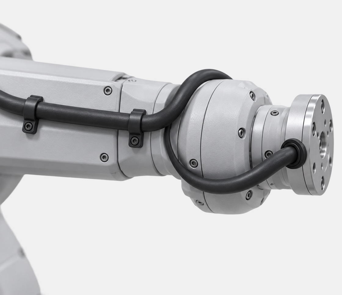 Robot cable routed along a six-axis robot forearm and around the wrist joint